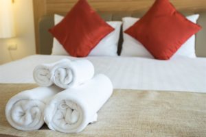 Rolled up towels on a bed