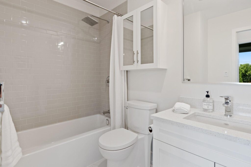 Alcove Bathtub in a white bathroom.