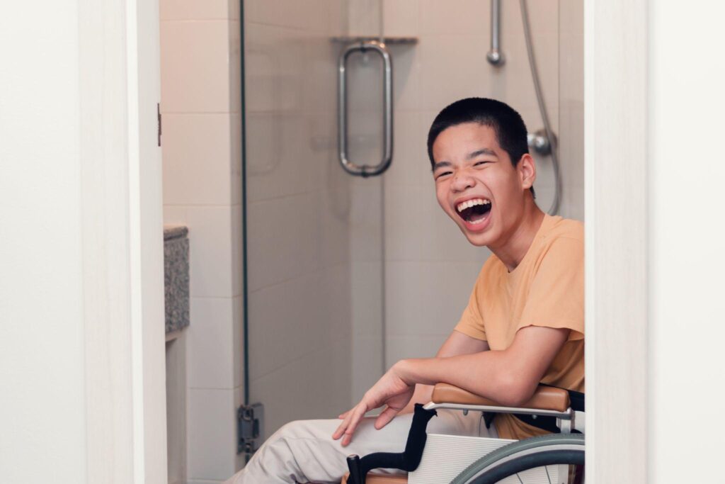 Happy asian disabled on wheelchair smiling with happiness face in toilet