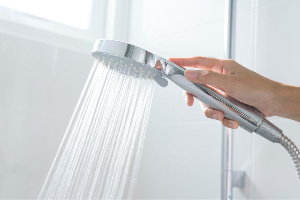 Shower head with water drops flowing.